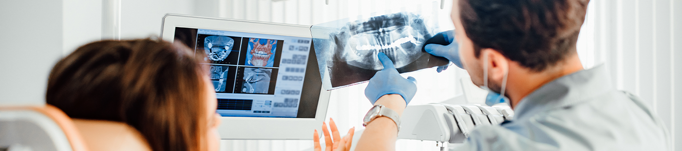 Arleta dentist showing a patient an x ray of their teeth