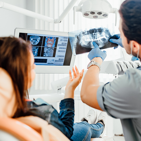 Dentist showing a patient x rays of their teeth