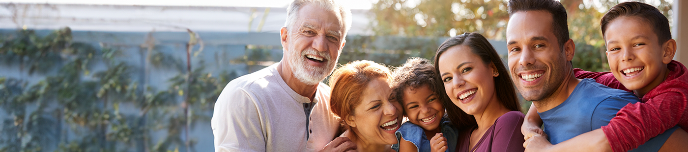 Family smiling outdoors after cosmetic dentistry in Arleta