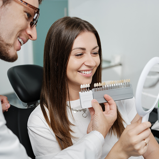 Woman being fitted for veneers by her cosmetic dentist