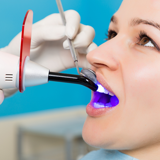 Dental patient having her teeth scanned