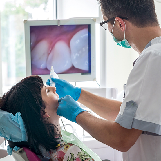 Dentist taking intraoral photos of a patients teeth