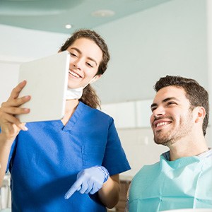 Dentist showing patient image on tablet