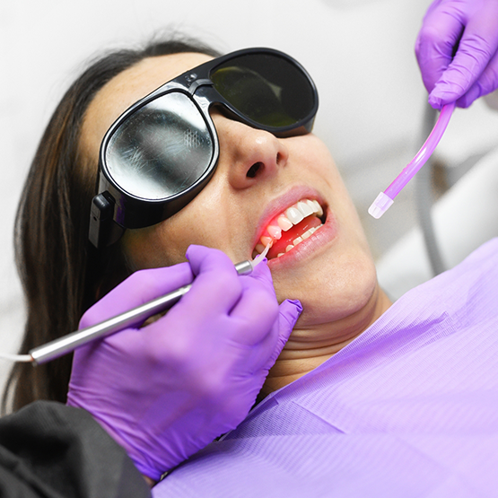 Woman receiving laser gum disease treatment