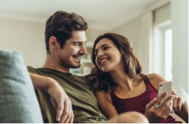 Man and woman sitting together on couch