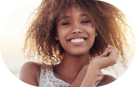 Young woman in white sleeveless blouse smiling