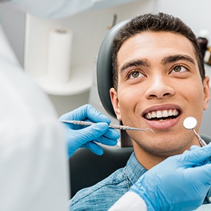 Man smiling at dentist before they examine his teeth