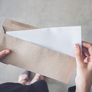 Bird’s eye view of a woman holding a cardboard envelope with letter