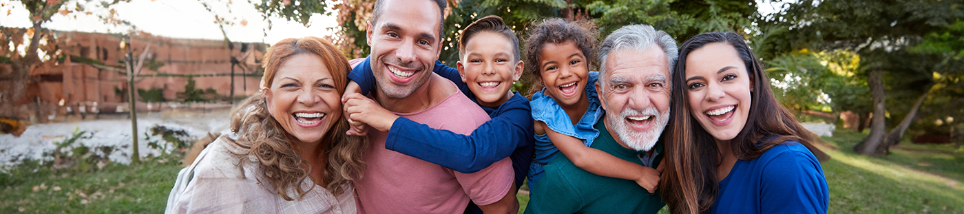 Family smiling in their backyard after sedation dentistry in Arleta