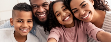 Family of four taking selfie together