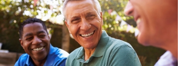 Three men laughing together outdoors