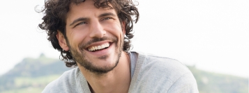 Smiling man with curly brown hair