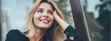 Blonde woman looking out a window